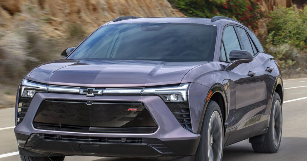 Front 7/8 view of the 2024 Chevrolet Blazer EV RS in Galaxy Gray Metallic driving down the road.