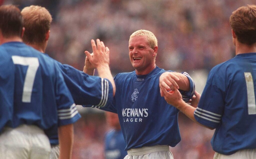 Paul Gascoigne celebrates with his Rangers teammates, September 1995