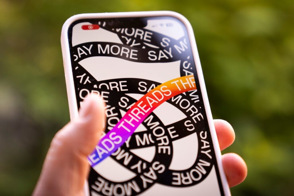 A phone is seen running the Instagram Threads app by Meta in this photo illustration.