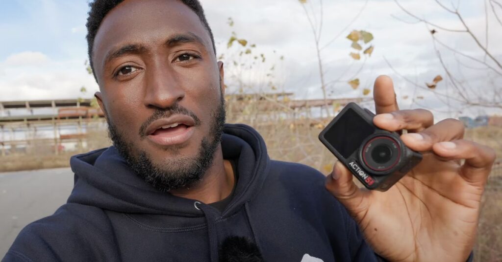 MKBHD holding an action camera