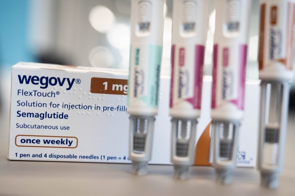 A container and several injection pens of Wegovy.