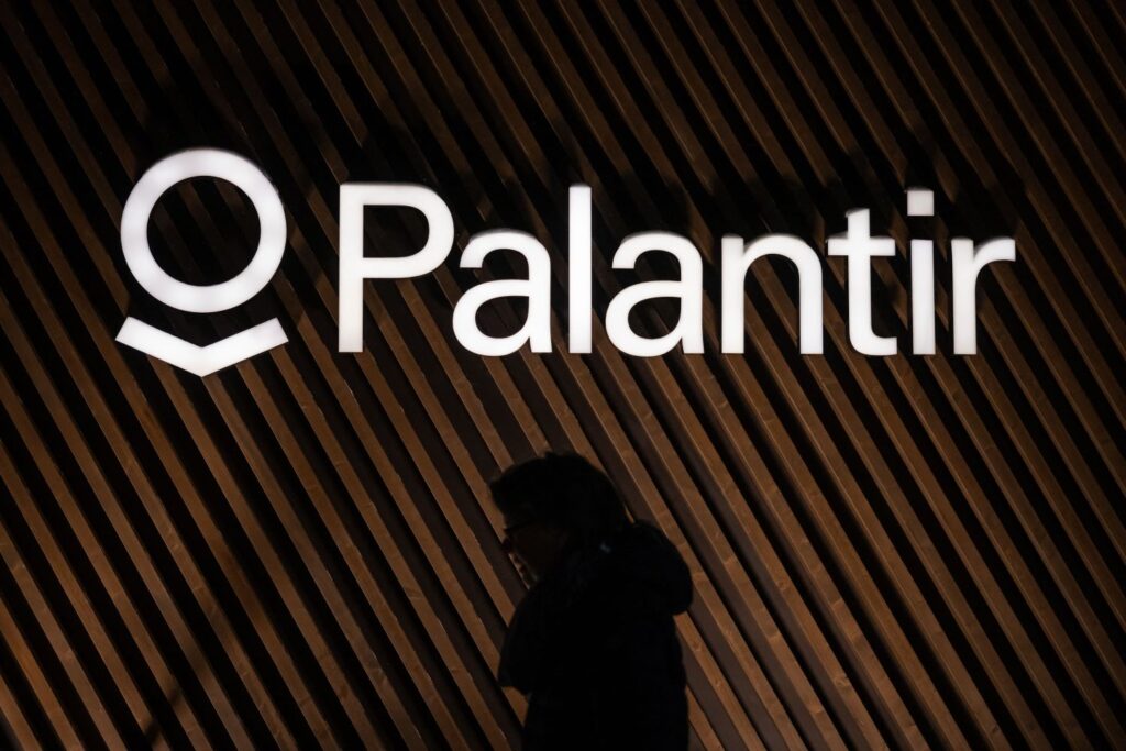 Palantir's logo against a shadowy background