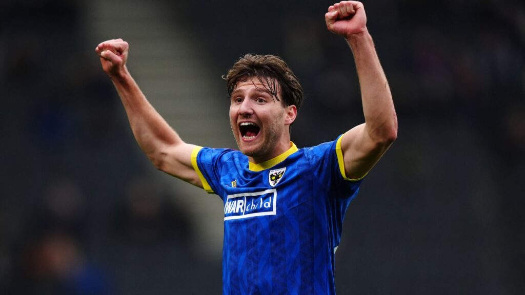 AFC Wimbledon's Riley Harbottle celebrates the win