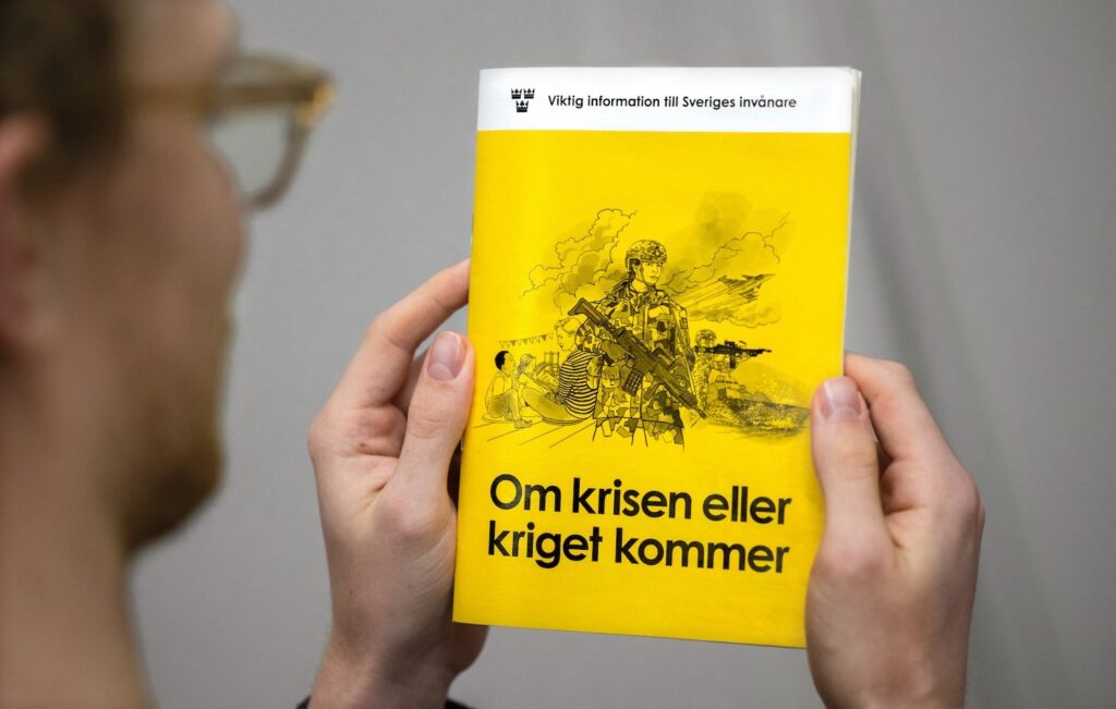 A man holds the new version of the preparedness booklet "If the crisis or war comes", that will be distributed to all households, on November 18, 2024 in Stockholm, Swede