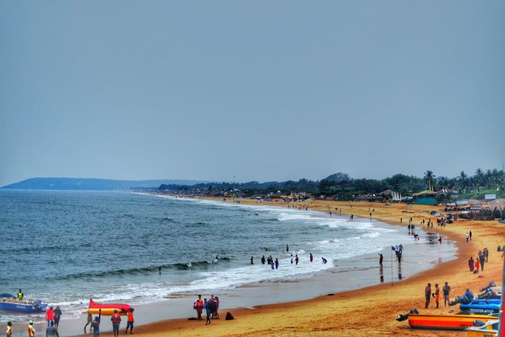 Visitors at a beach in Goa's Candolim.