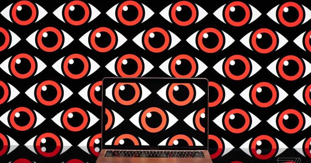 Art rendering of transparent laptop in front of a wall of surveilling eyes.