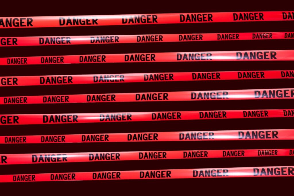 an illustration showing reams of red "danger" tape over a dark solid background