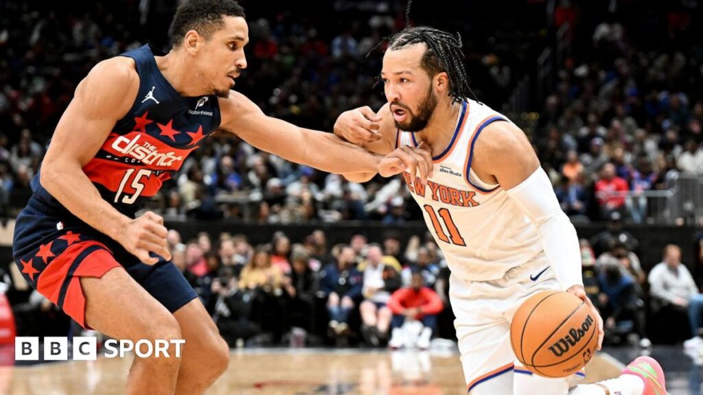 Jalen Brunson of the New York Knicks handles the ball against Malcolm Brogdon of the Washington Wizards