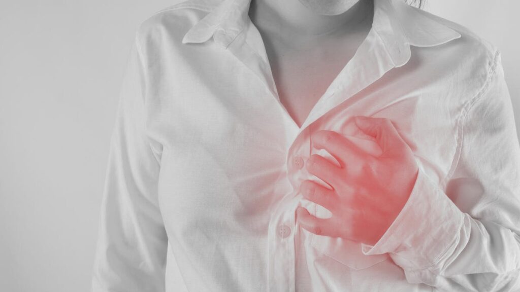 Woman Having Chest Pain Against White Background.