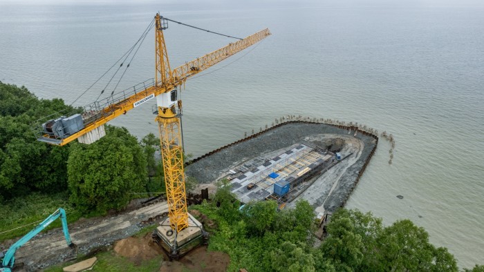 small jetty and crane by coastline