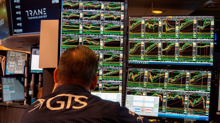 A specialist studies monitors on the New York Stock Exchange trading floor in New York