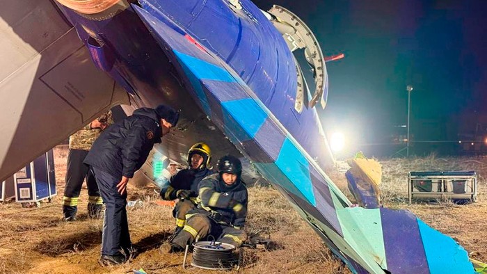 Rescuers work at the site of the crashed Azerbaijan Airlines aircraft on Thursday