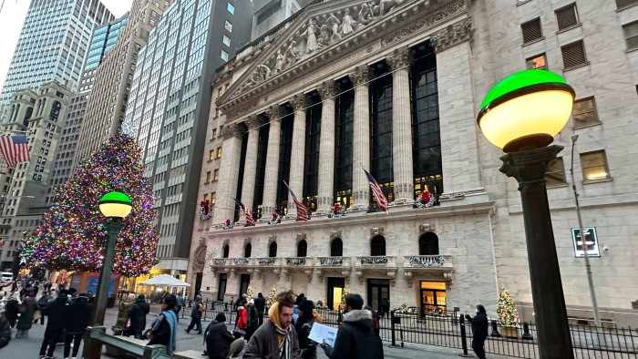 People walk near the New York Stock Exchange