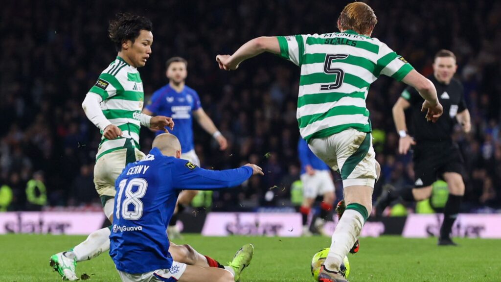 GLASGOW, SCOTLAND - DECEMBER 15: Celtic's Liam Scales (R) pulls down Rangers' Vaclav Cerny at the edge of the penalty box during the Premier Sports Cup Final between Celtic and Rangers at Hampden Park, on December 15, 2024, in Glasgow, Scotland. (Photo by Craig Williamson / SNS Group)