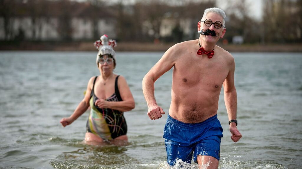 Hardy swimmers brave chilly waters with traditional New Year's dip