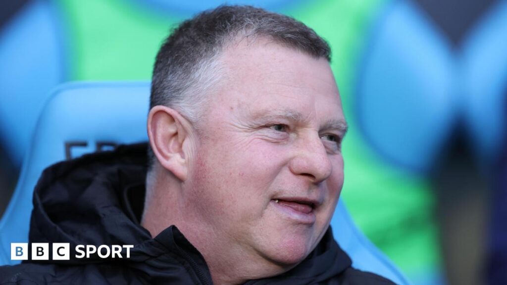 Mark Robins sitting in the dugout during his time as Coventry City boss