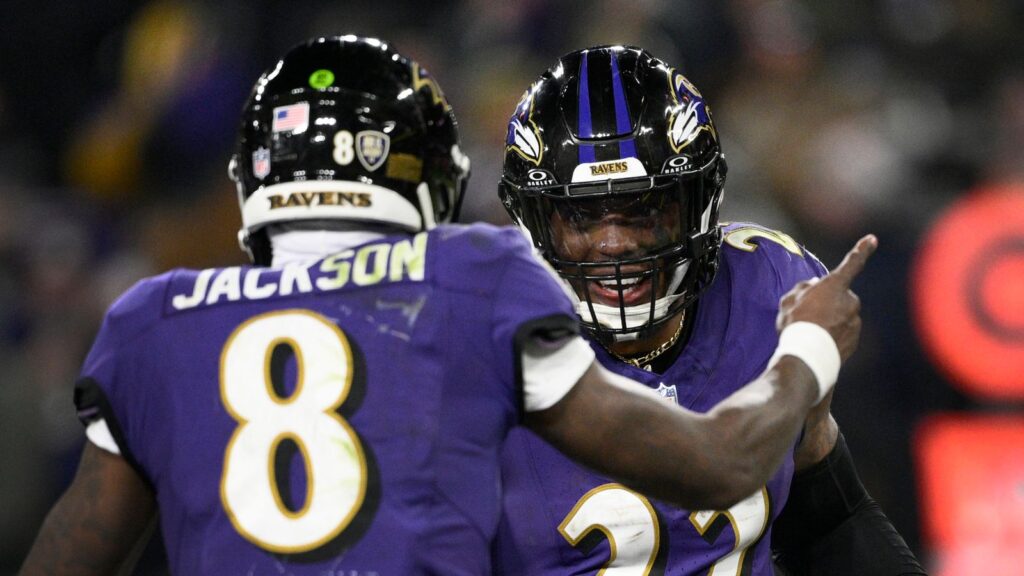 Baltimore Ravens running back Derrick Henry (22) is congratulated by teammate Lamar Jackson (8) after scoring during the second half of an NFL football game against the Cleveland Browns Saturday, Jan. 4, 2025, in Baltimore. (AP Photo/Nick Wass)